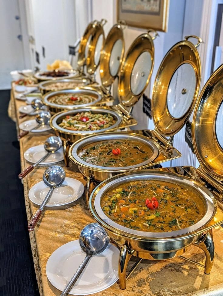 Indoor gold-themed buffet counter by Negi Catering for an event