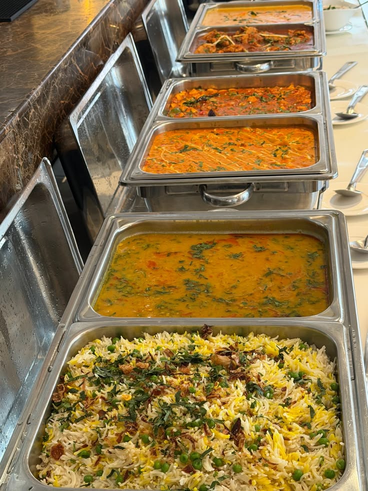 Freshly cooked dal and rice served from steel counters by Negi Catering